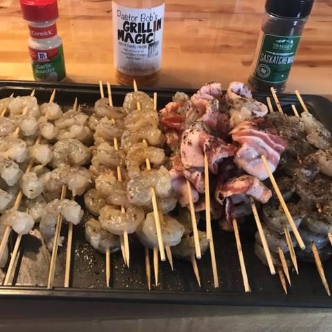 Shrimp skewers ready for the grill, with seasonings